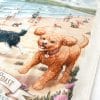 A close up of the tea towel featuring a ginger cavoodle running along Umina Beach